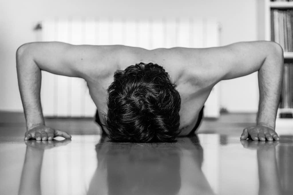 weak man doing press ups