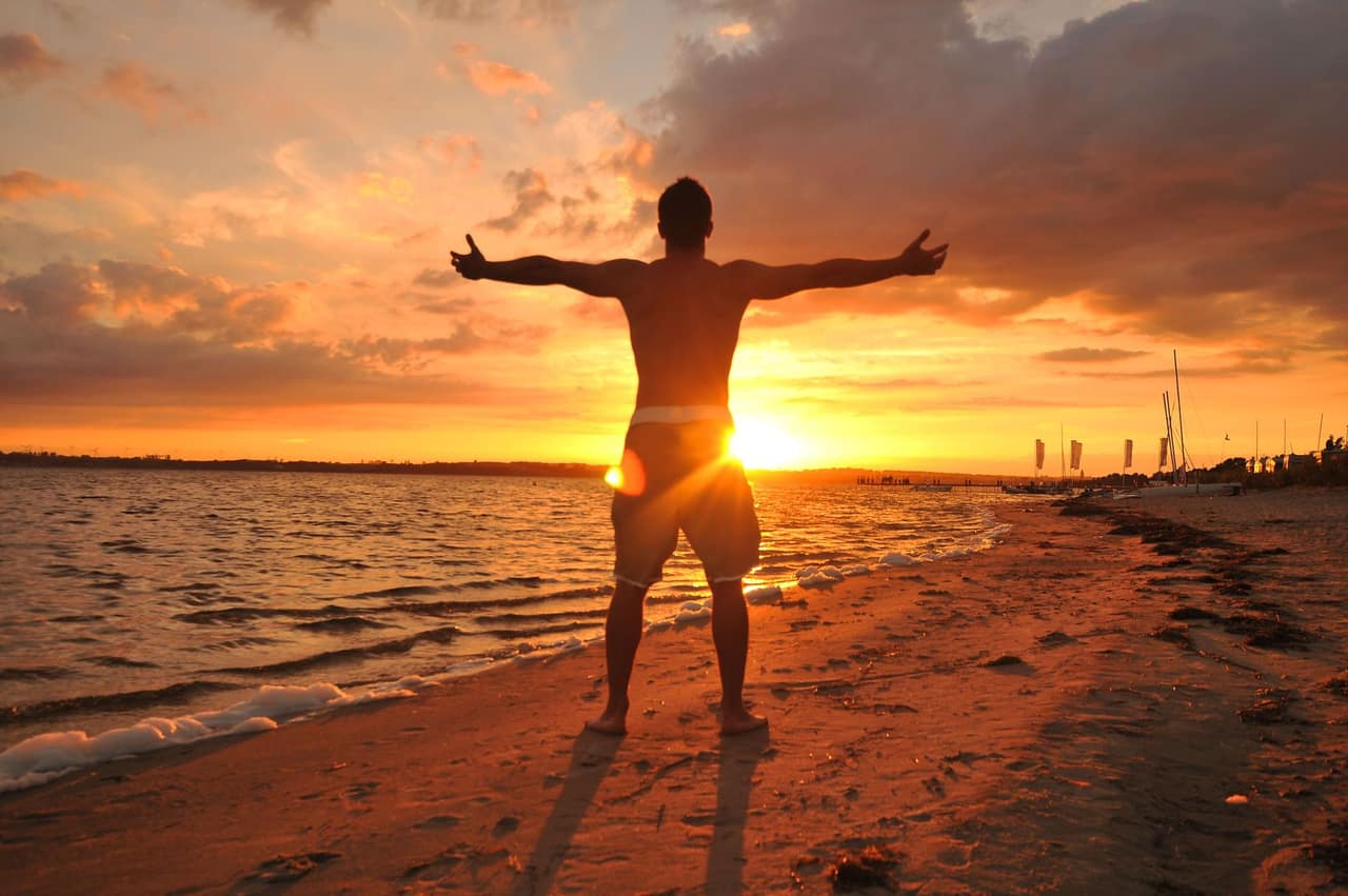 Man with arms open toward the sun