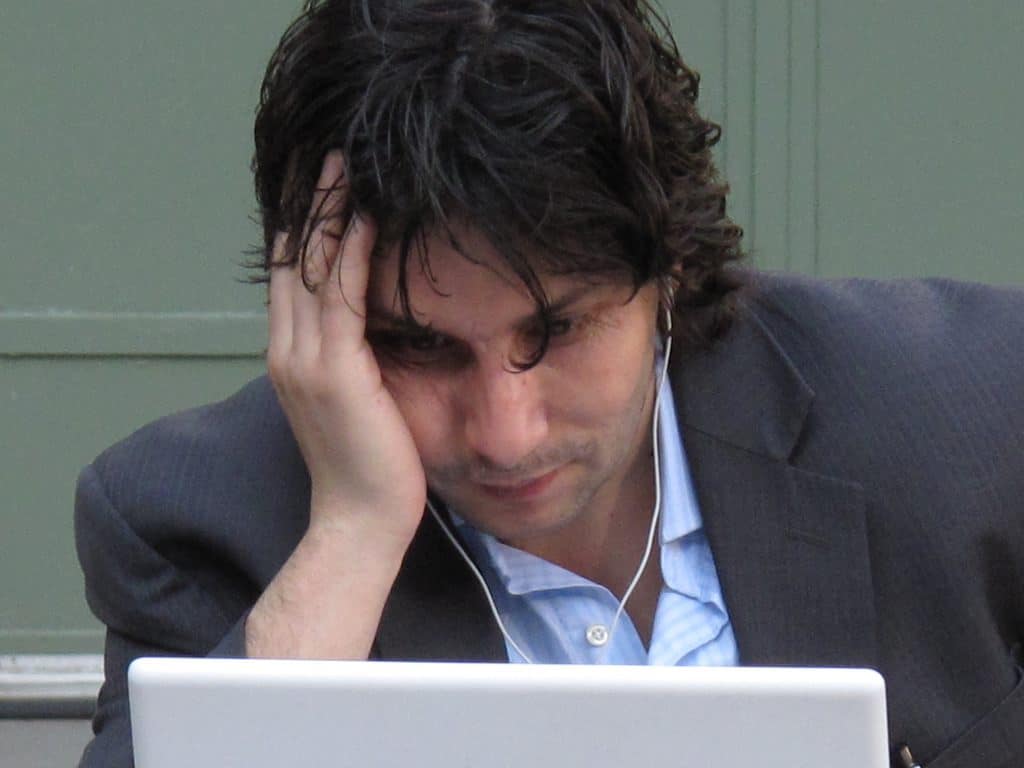 man staring at his laptop