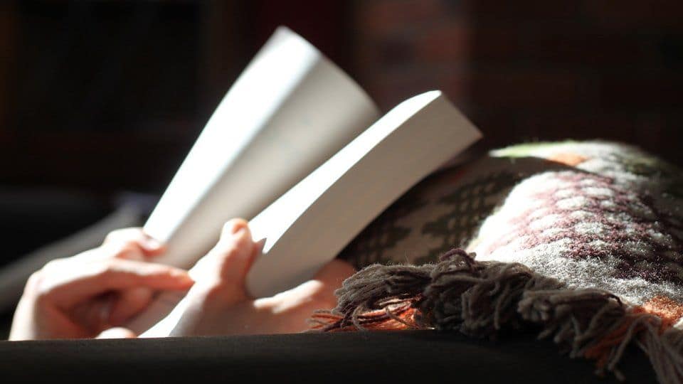 image of a person opening a book
