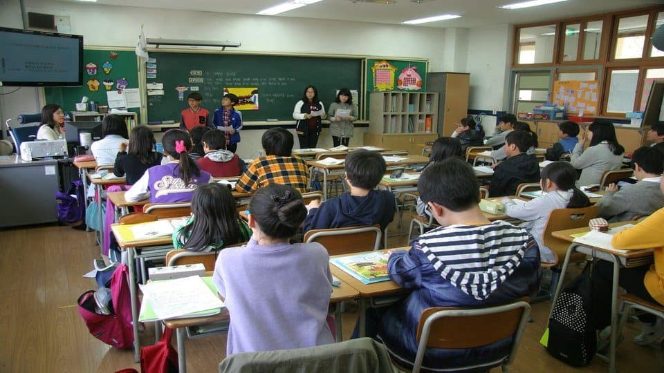 image of a teacher and children in a classroom