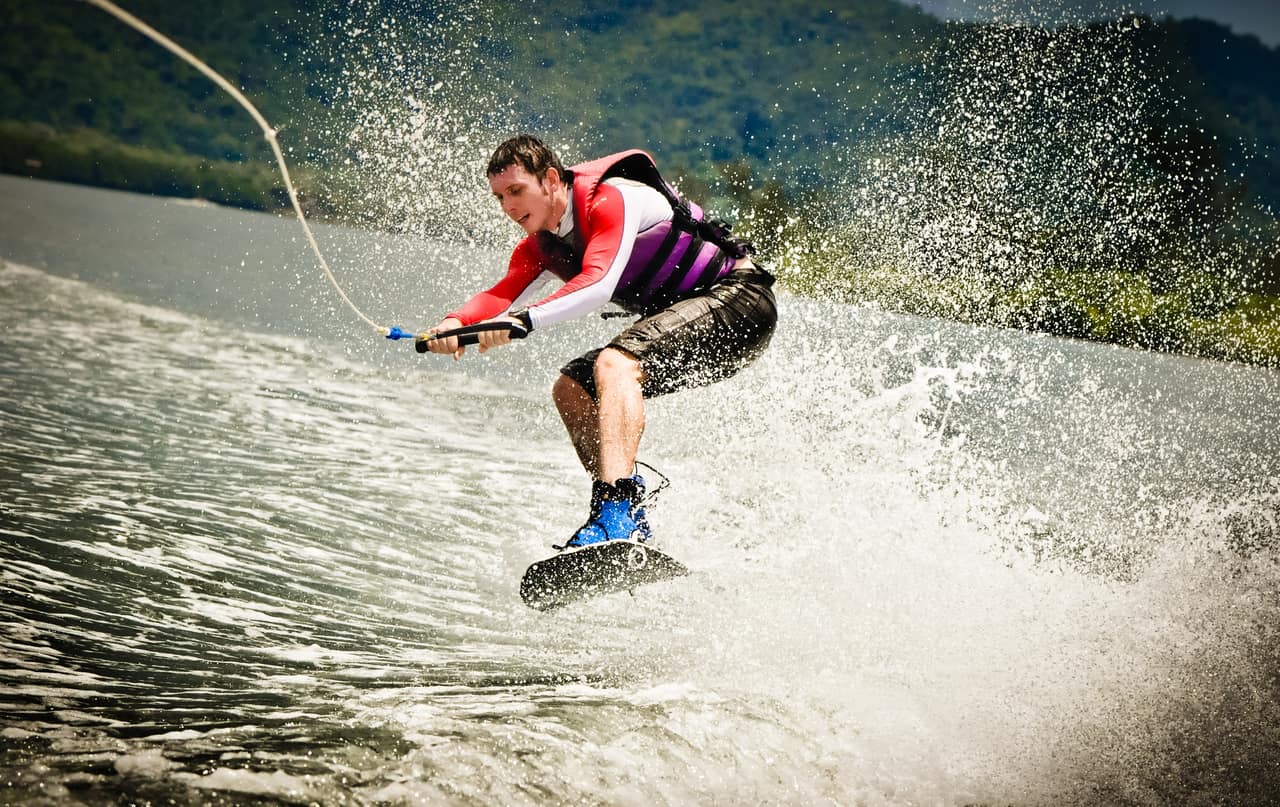 Man Jumping On Wake Board On Water