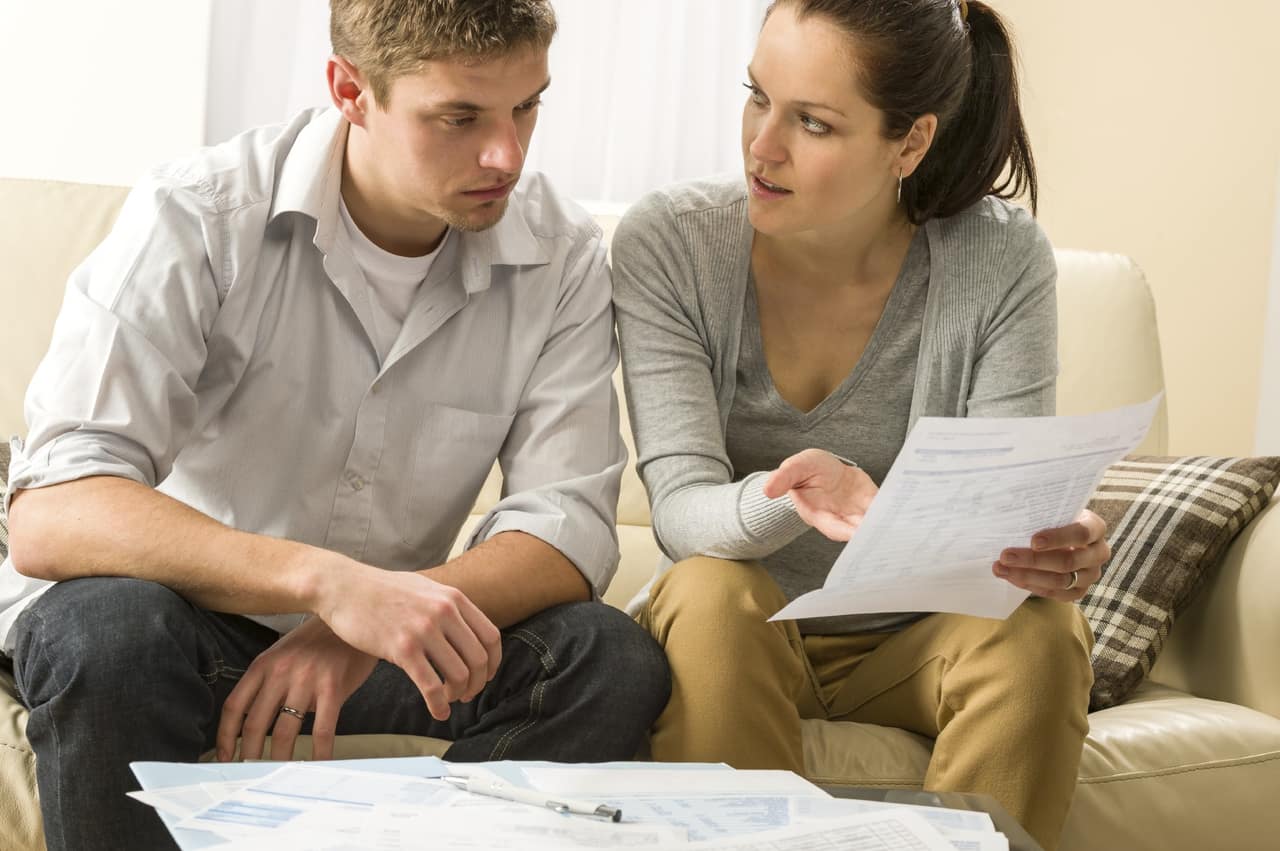 Worried couple talking about their expenses and financial problems