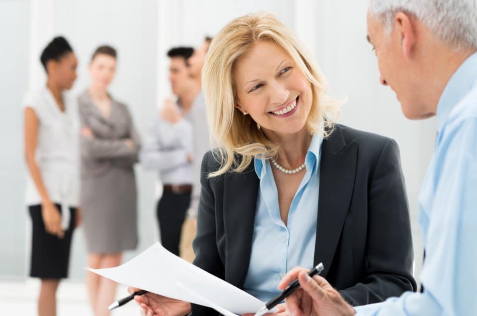 Portrait Of Happy Business People Discussing Together In Office