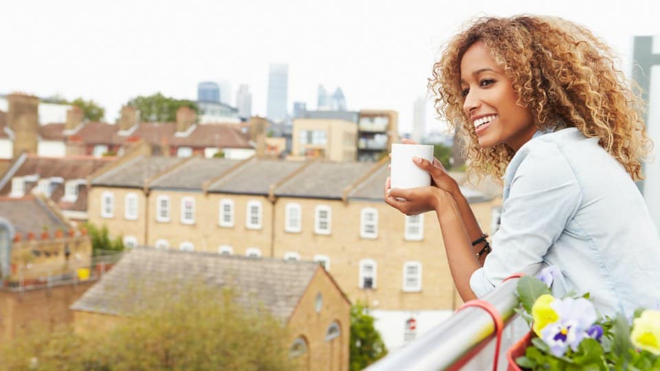 Woman Relaxing Outdoors On Rooftop Garden