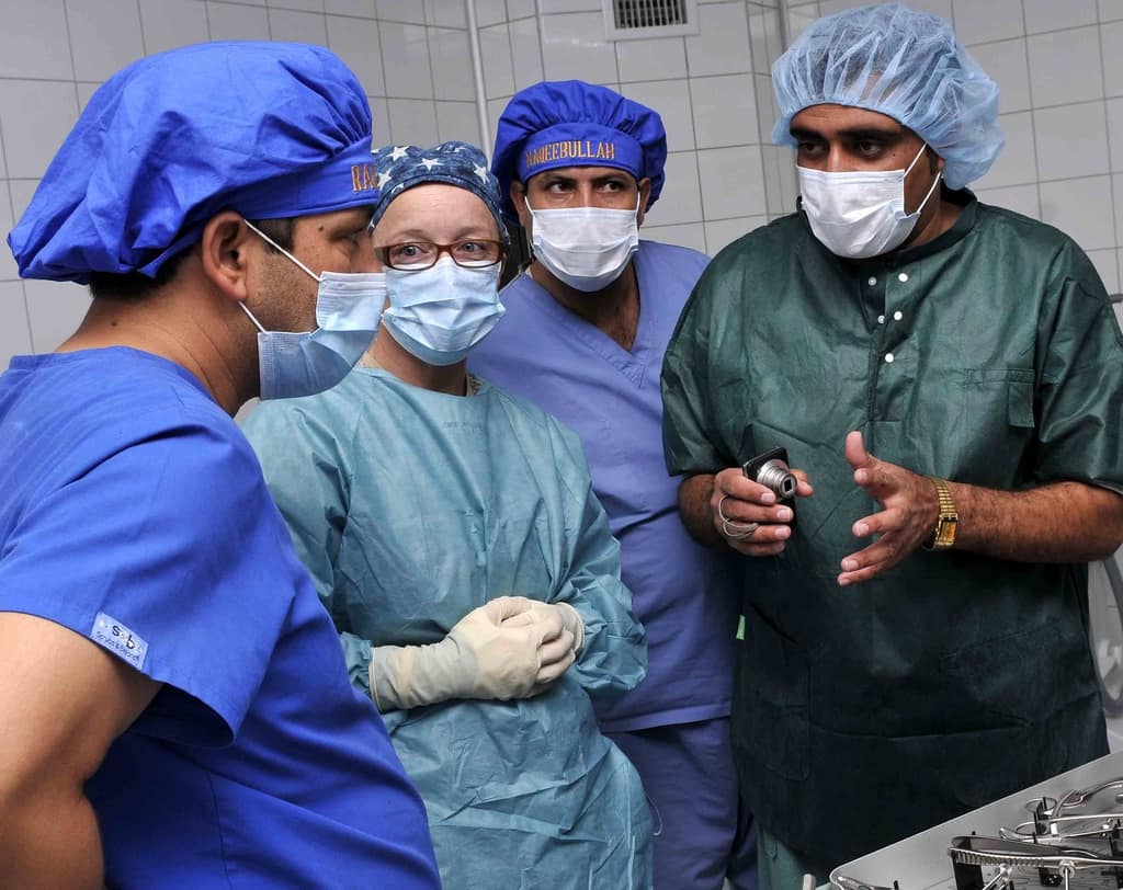 110910-N-8377A-035, CAMP SHAHEEN, Mazar-e Sharif, Balkh province, Afghanistan (September 10, 2011)  ANA and U.S. operating room nurses listen as Afghan National Army Dr., Sayed Nabiullah, (right) interprets for the group prior to starting an IM Rodding procedure to fix a broken leg at the ANA Regional Military Hospital, located within Camp Shaheen. Members of the Regional Support Command North, Medical Embedded Training Team on Camp Mike Spann, along with a Swedish task force anesthesiologist who was at Provincial Reconstruction Team, Mazar-e Sharif, provided operating room support for the procedure alongside ANA medical personnel. (U.S. Navy Photo by Chief Mass Communication Specialist Michael Ard/Released)