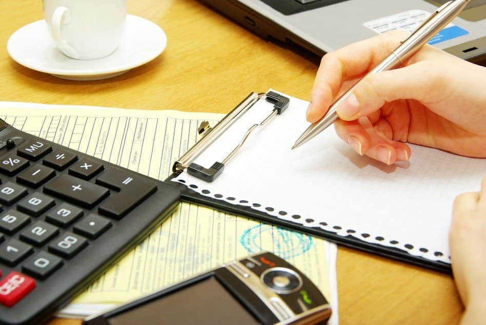Closeup of a young women calculating bills