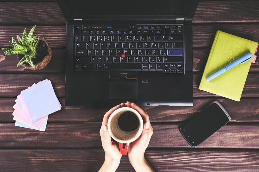 Coffee mug in hand. Woman working in the office regarding accounting