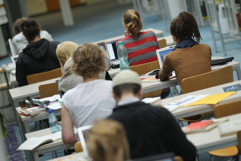 BERLIN, GERMANY - SEPTEMBER 20:  Students study with their laptop computers in the Pedagogical Library at the Freie Universitaet university on September 20, 2011 in Berlin, Germany. German universities recorded a record 2.218 million matriculations in the 2010/2011 winter semester, a rise of 4.5%, and expect even more students in the coming winter semster, which starts in October. The end of compulsory military service in the Bundeswehr, the German armed forces, which went into effect earlier this year, is a major contributing factor to the rise in the numbers of students arriving at universities across the country.  (Photo by Sean Gallup/Getty Images)