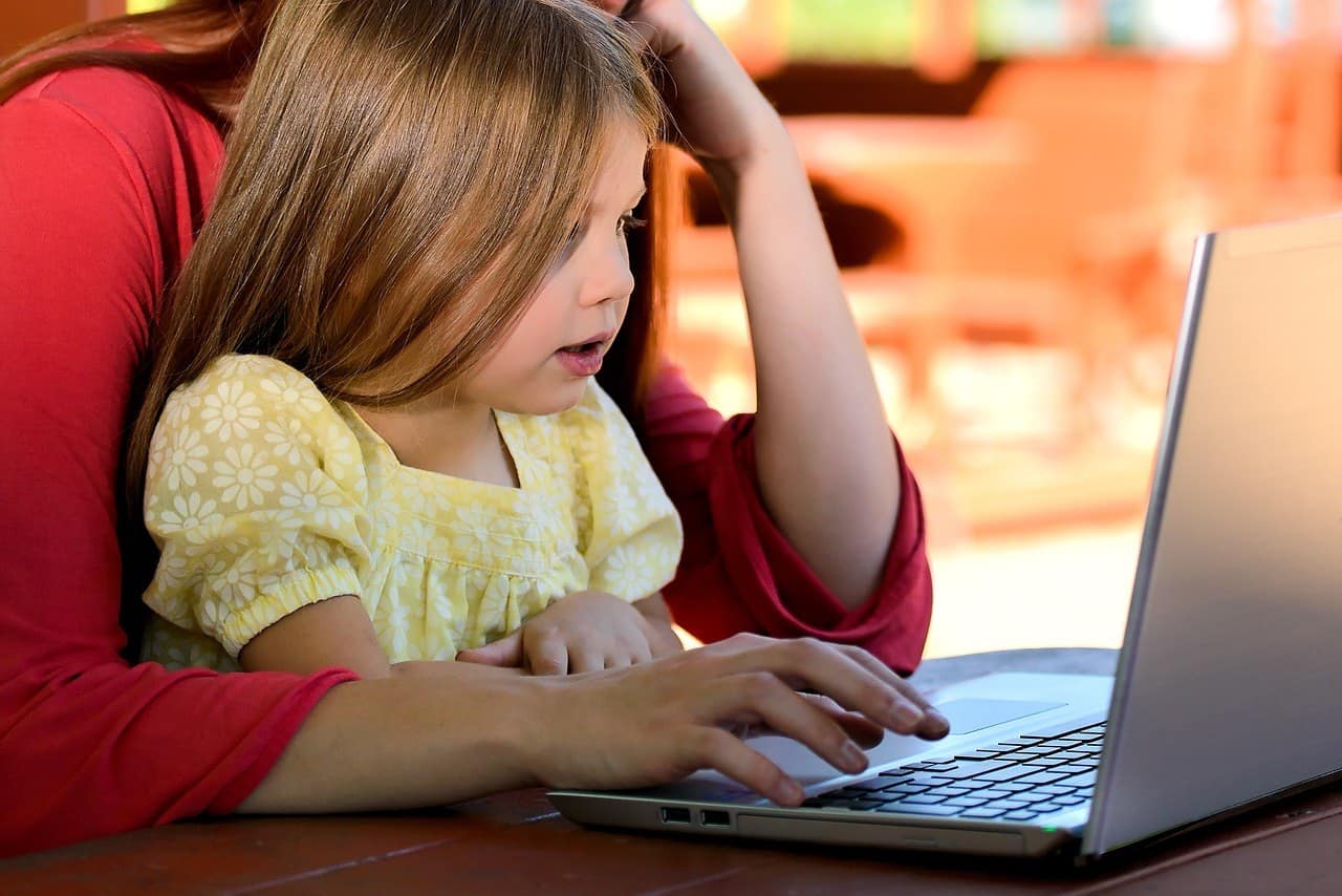 mom and daughter typing