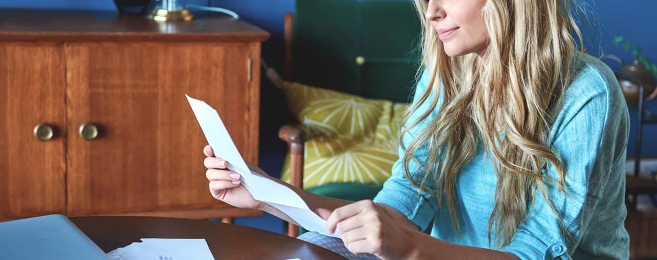 young independent woman, sorting out monthly financials credit card bills and rent