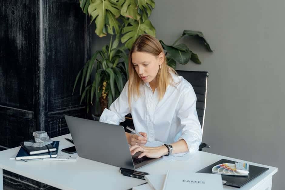 focused woman working on laptop demonstrating attention and productivity
