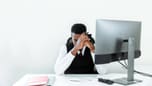 Businessman stressed at computer, representing procrastination struggle