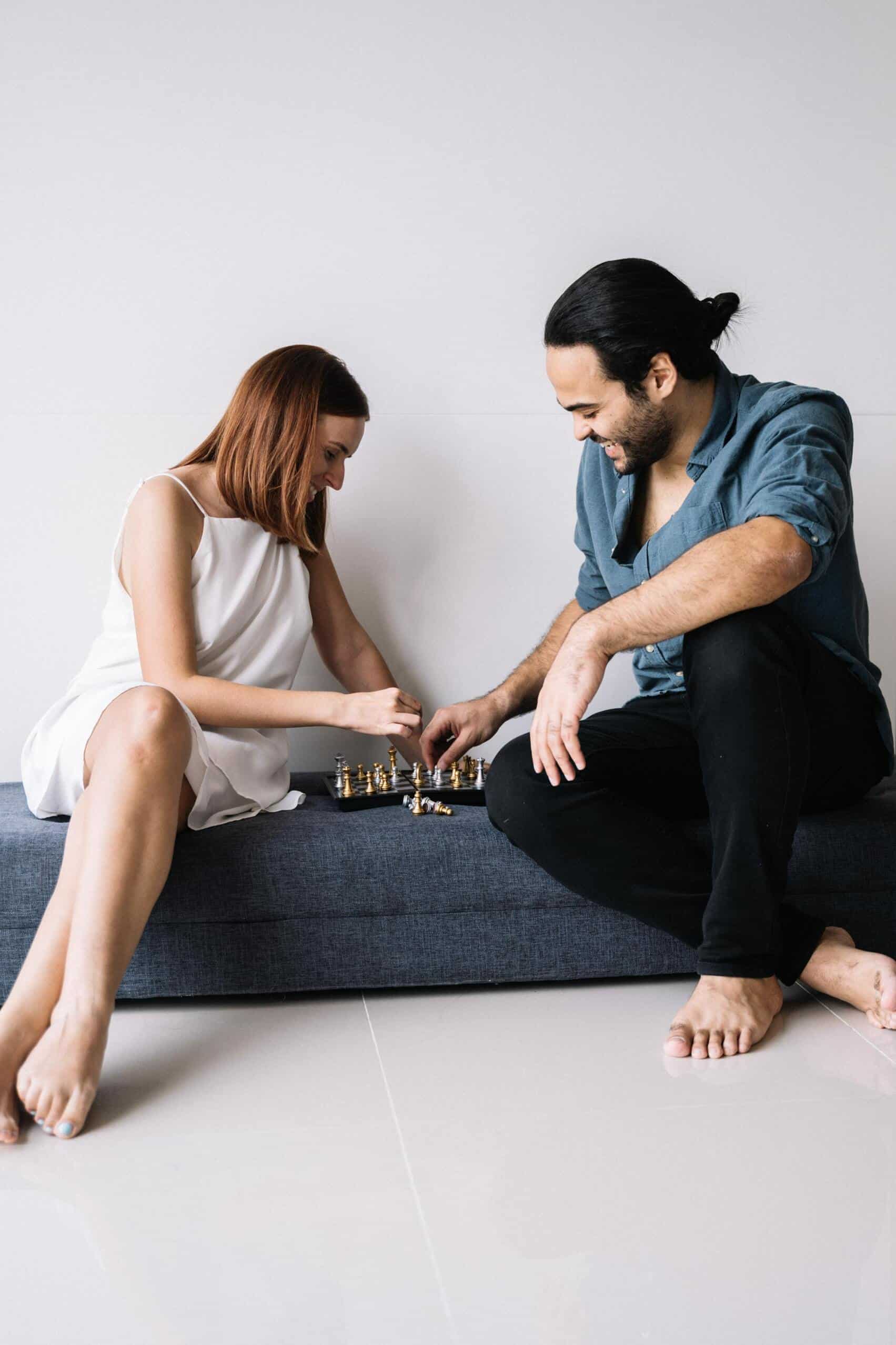 couple playing chess on the floor