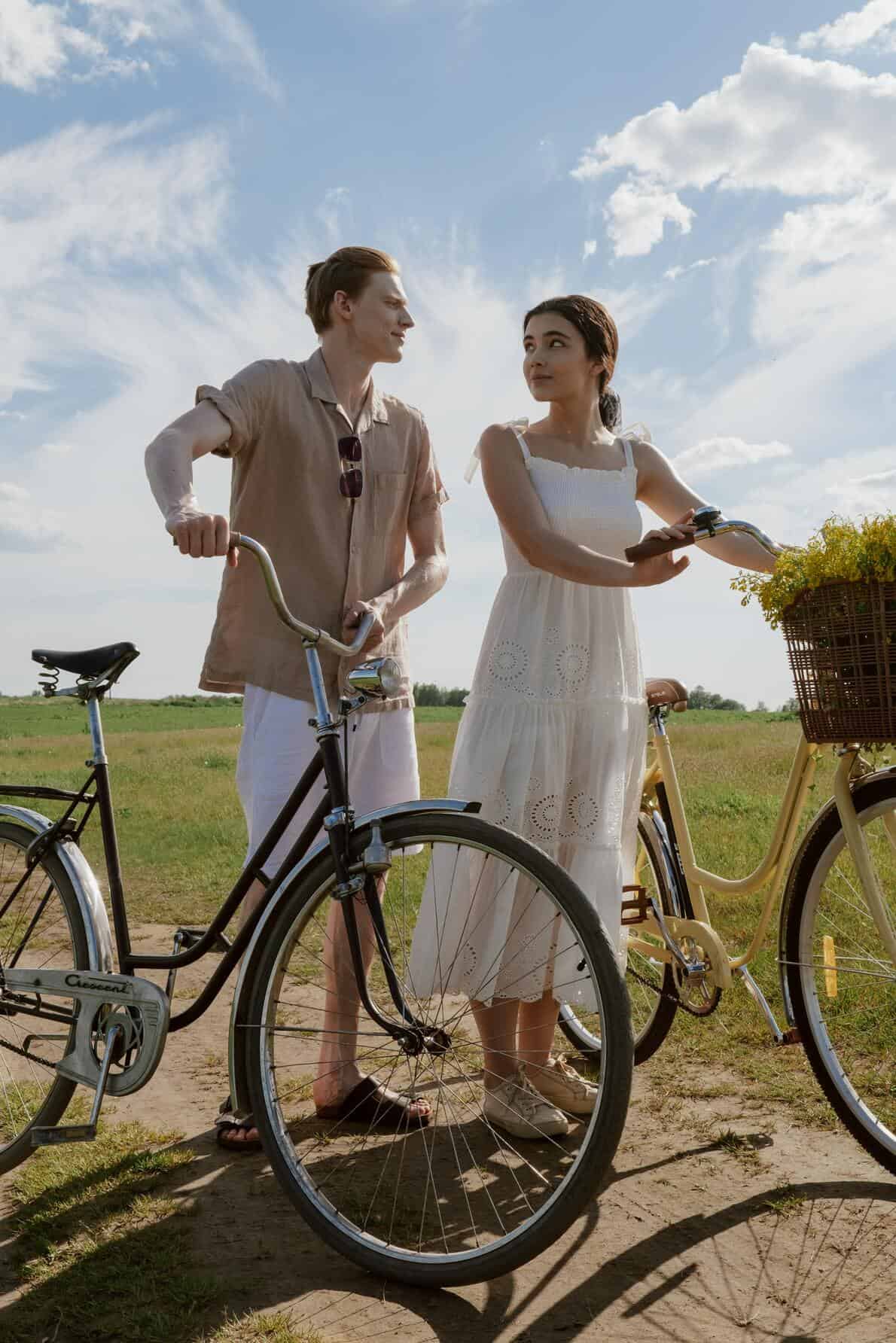 couple standing behind bikes