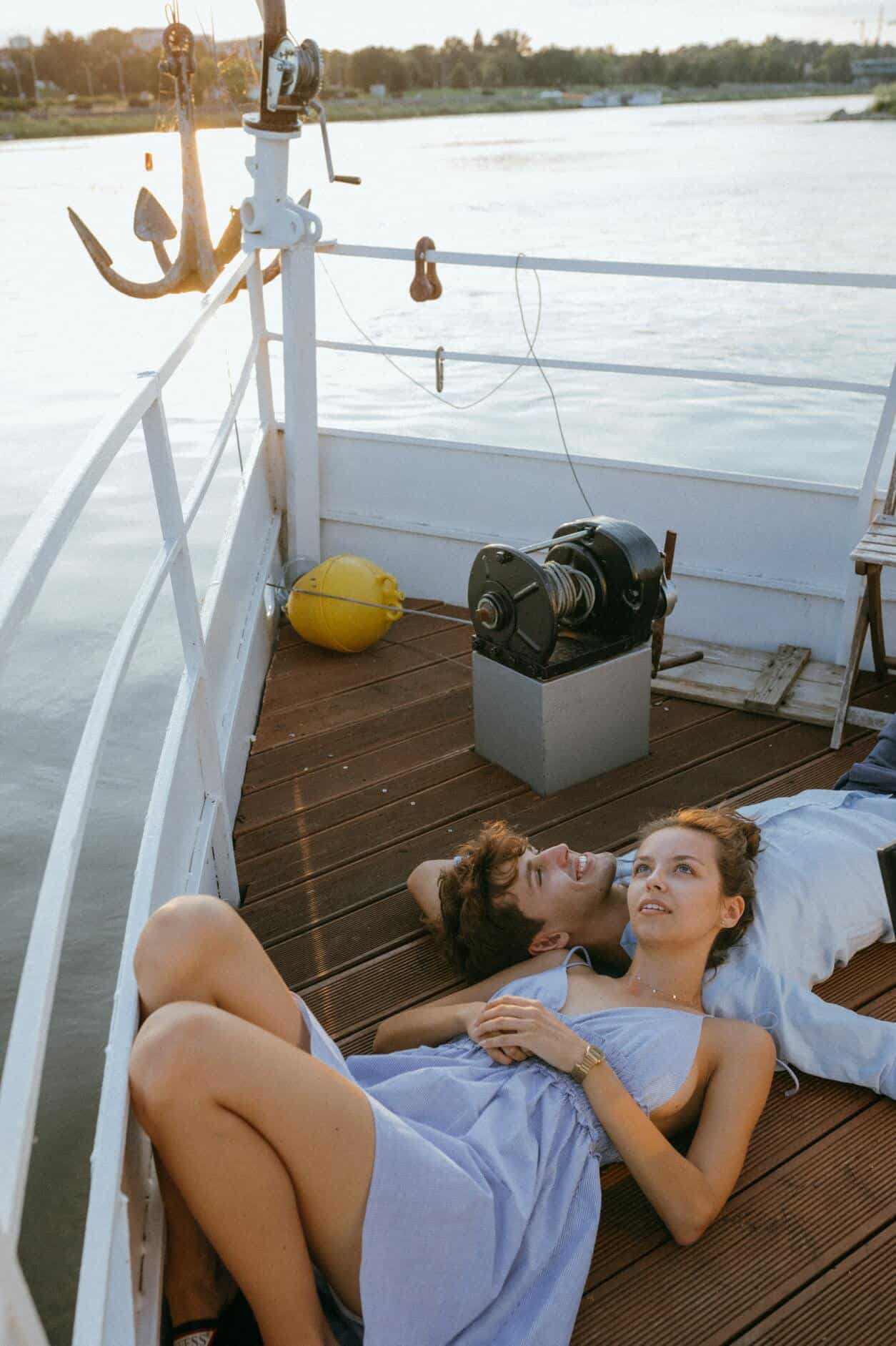 man and woman lying on boatdeck