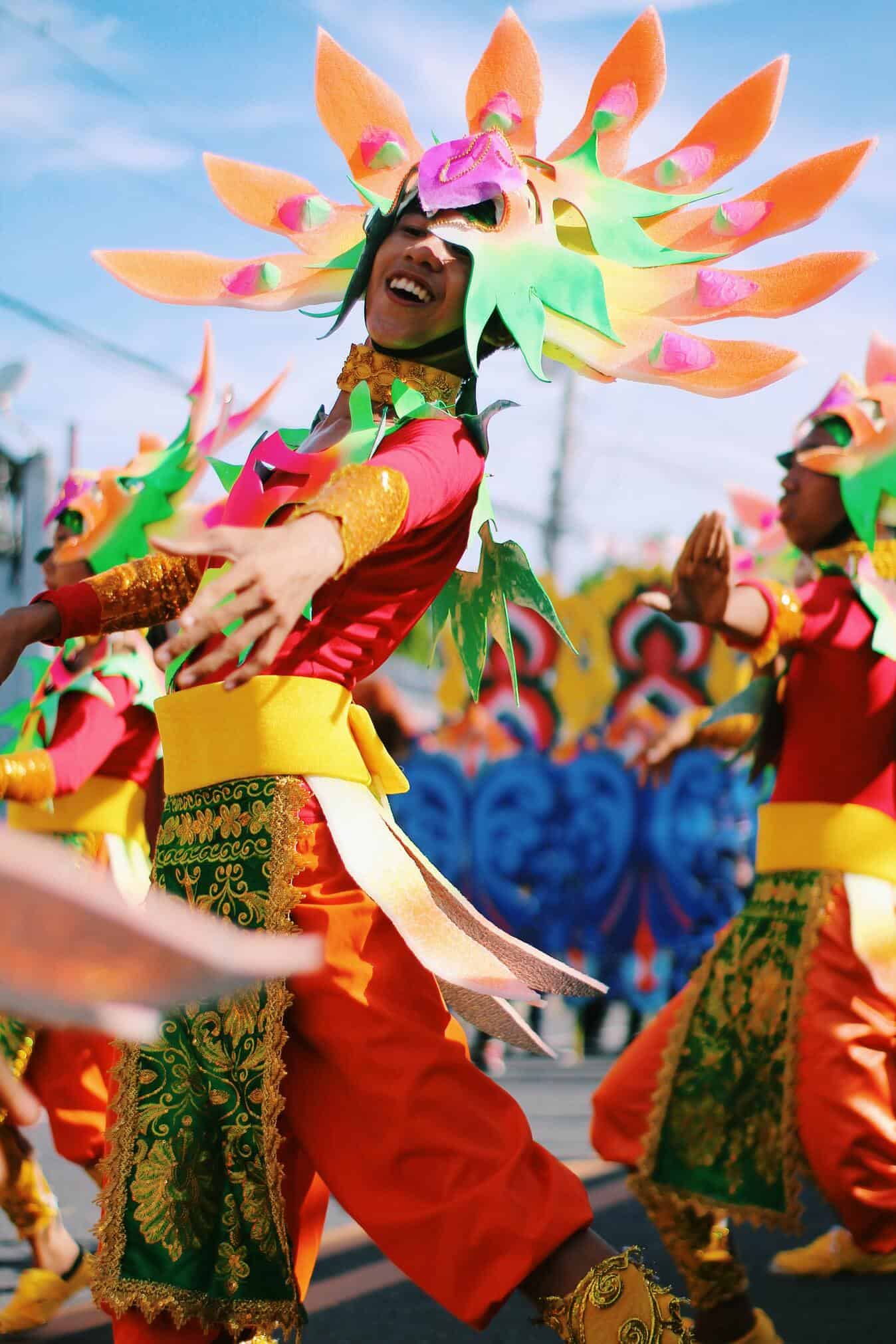 man in colorful costume dancing in Bicol festival
