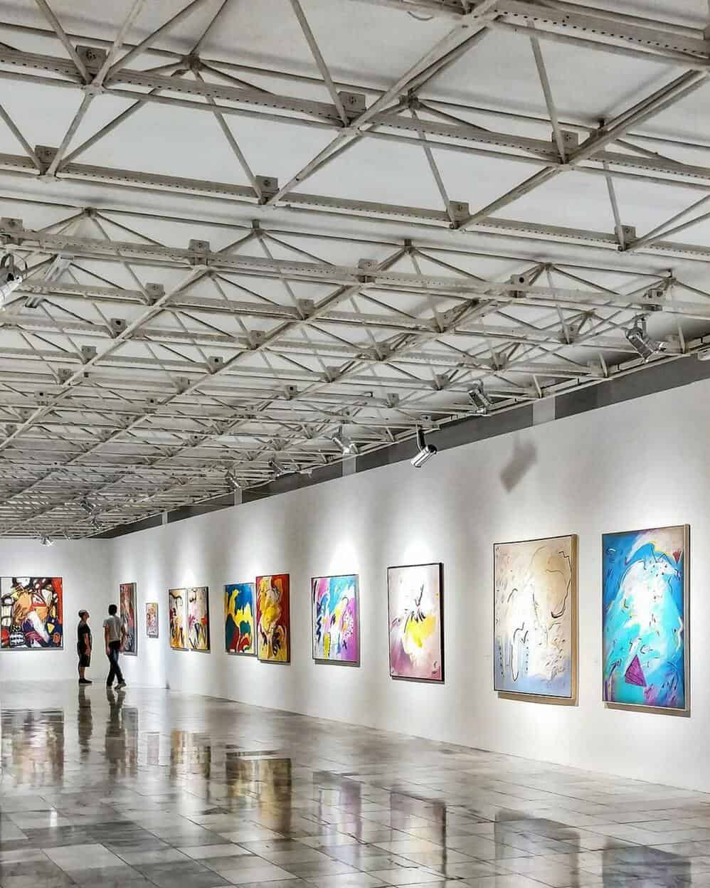 colorful paintings hanging on the wall of a museum in brazil