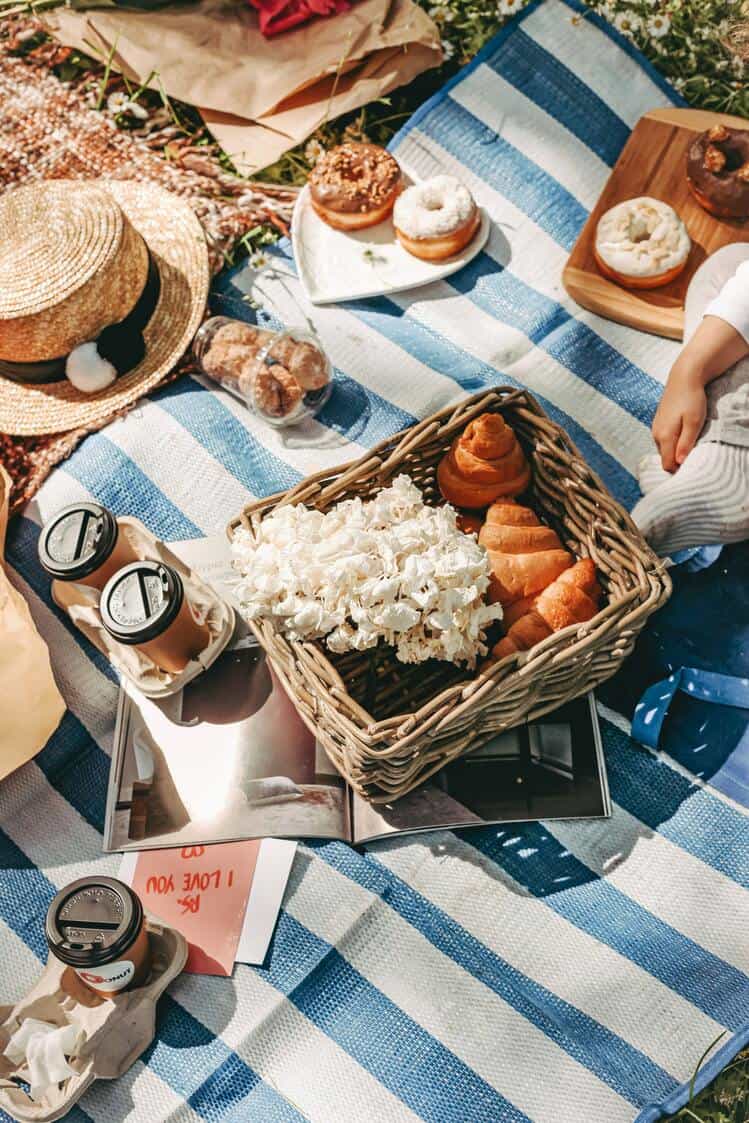 picnic mat with pastries and coffee