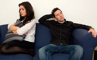 Young couple on a sofa after a row argument