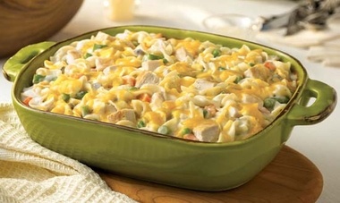 Chicken Noodle Casserole in a green baking dish on a wooden surface