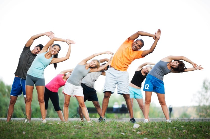 Group of people doing stretching exercises.
