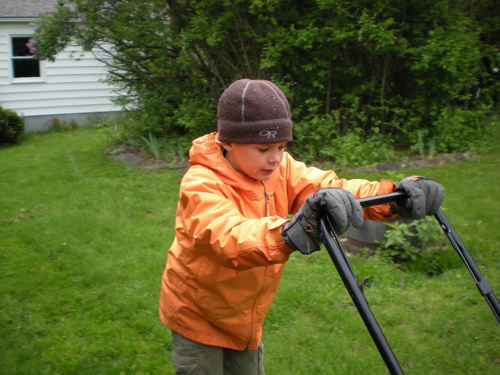 child mowing the lawn