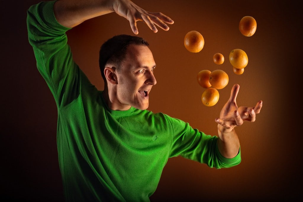 man levitating oranges