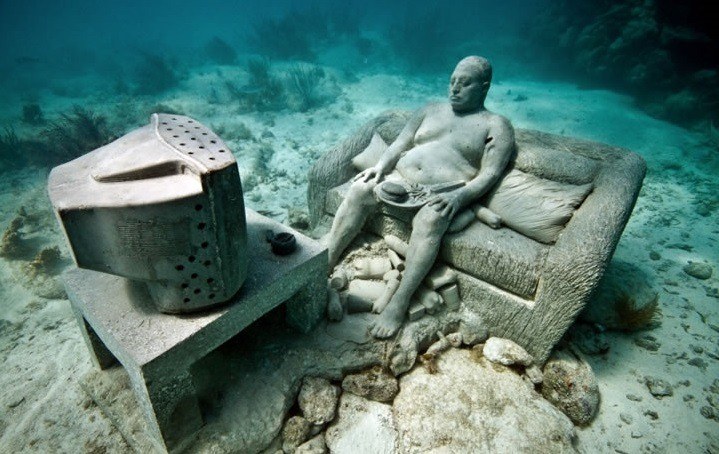 Man on couch underwater sculpture