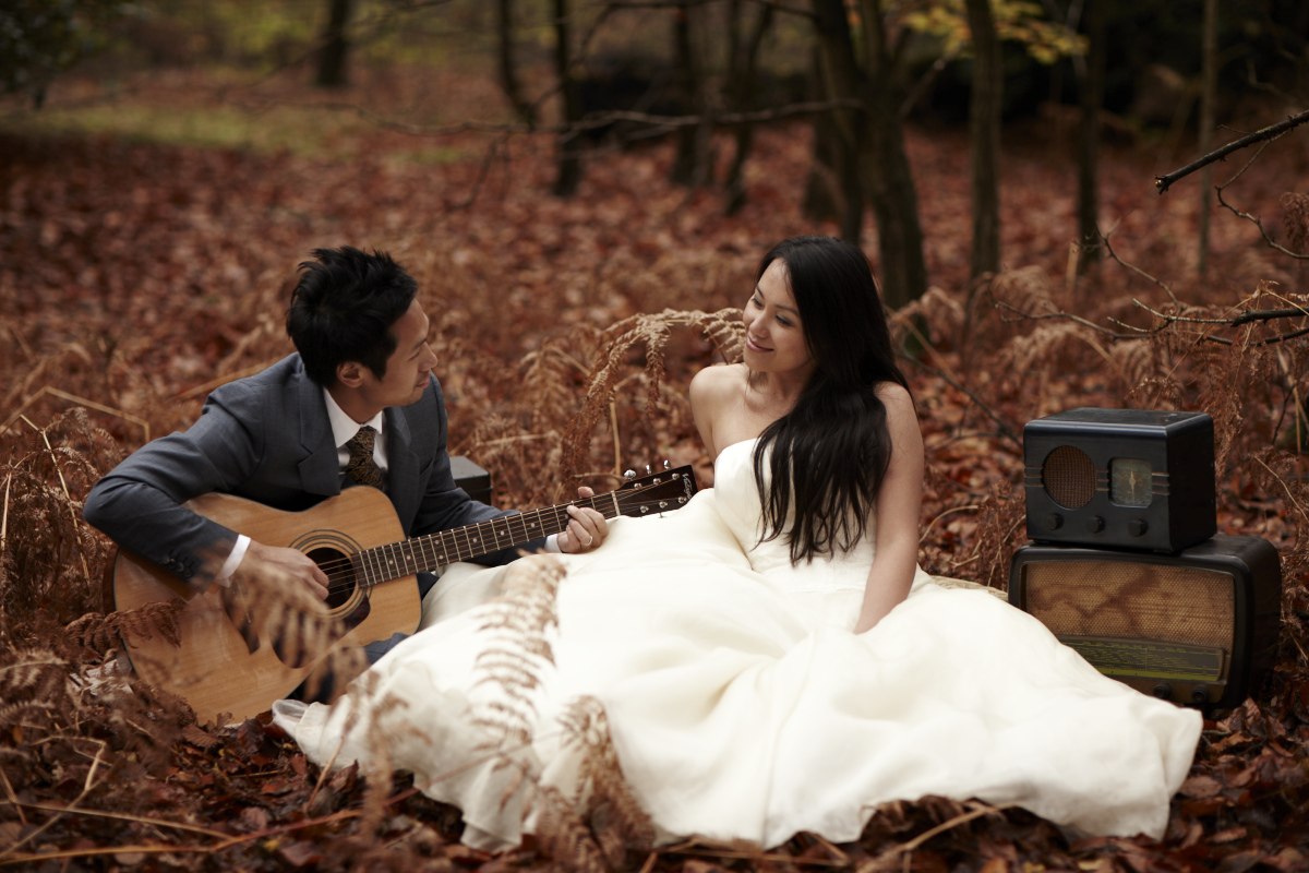 Bride and groom in autumn leaves