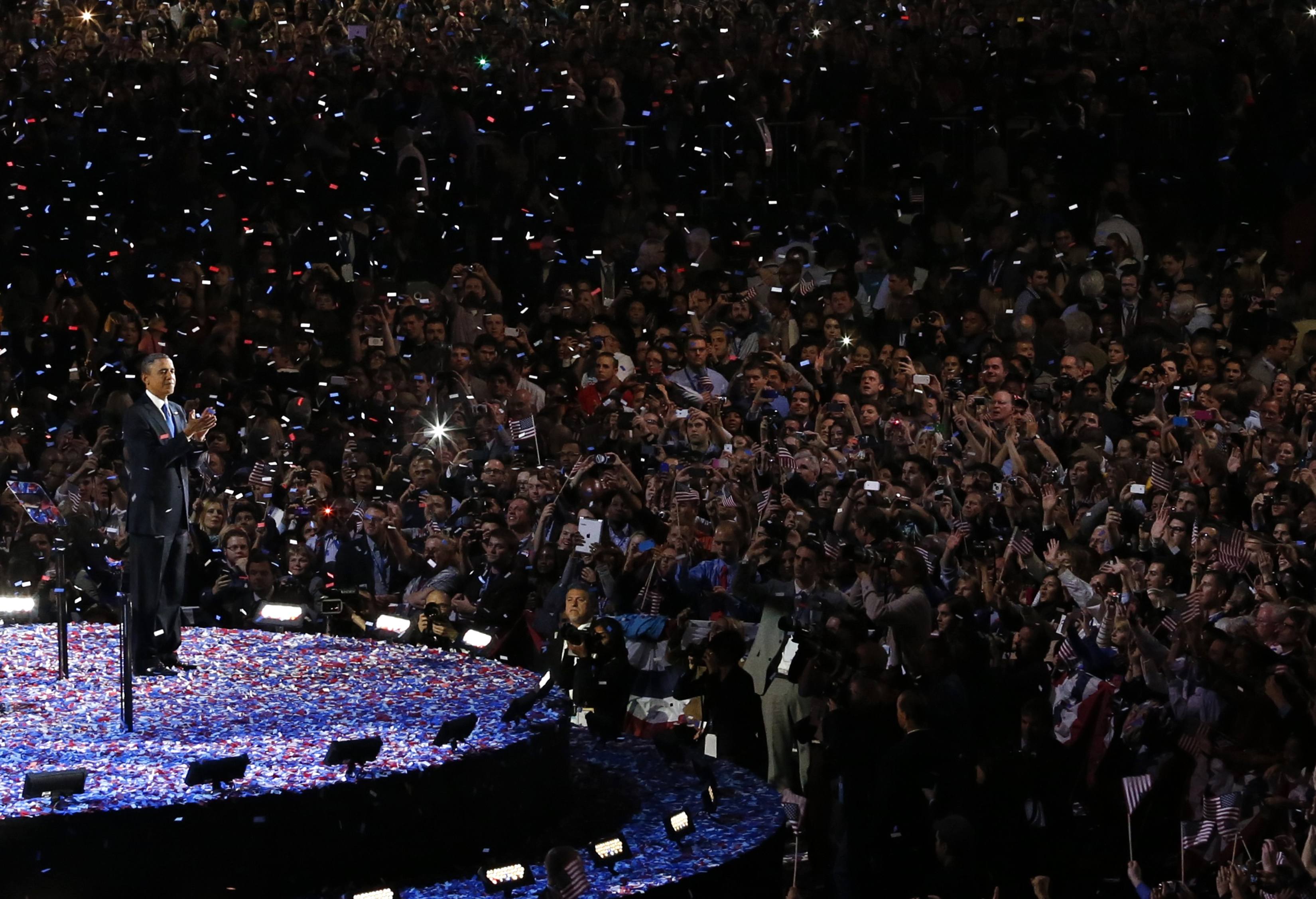 U.S. President Barack Obama applauds as he addresses supporters during his election night victory rally in Chicago