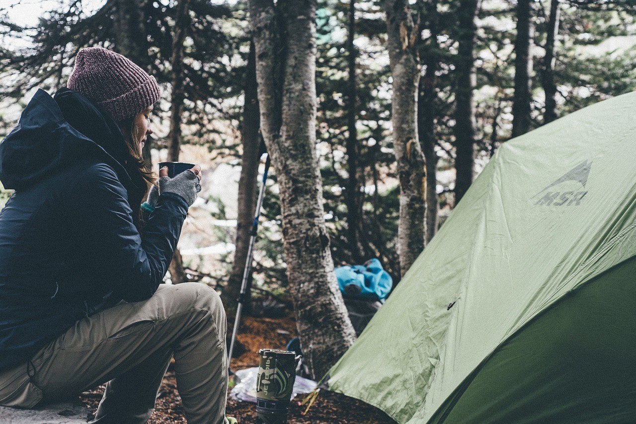 Woman camping in forest