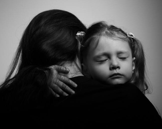 Depression daughter hugging her mother with sad face. Closeup portrait black and white