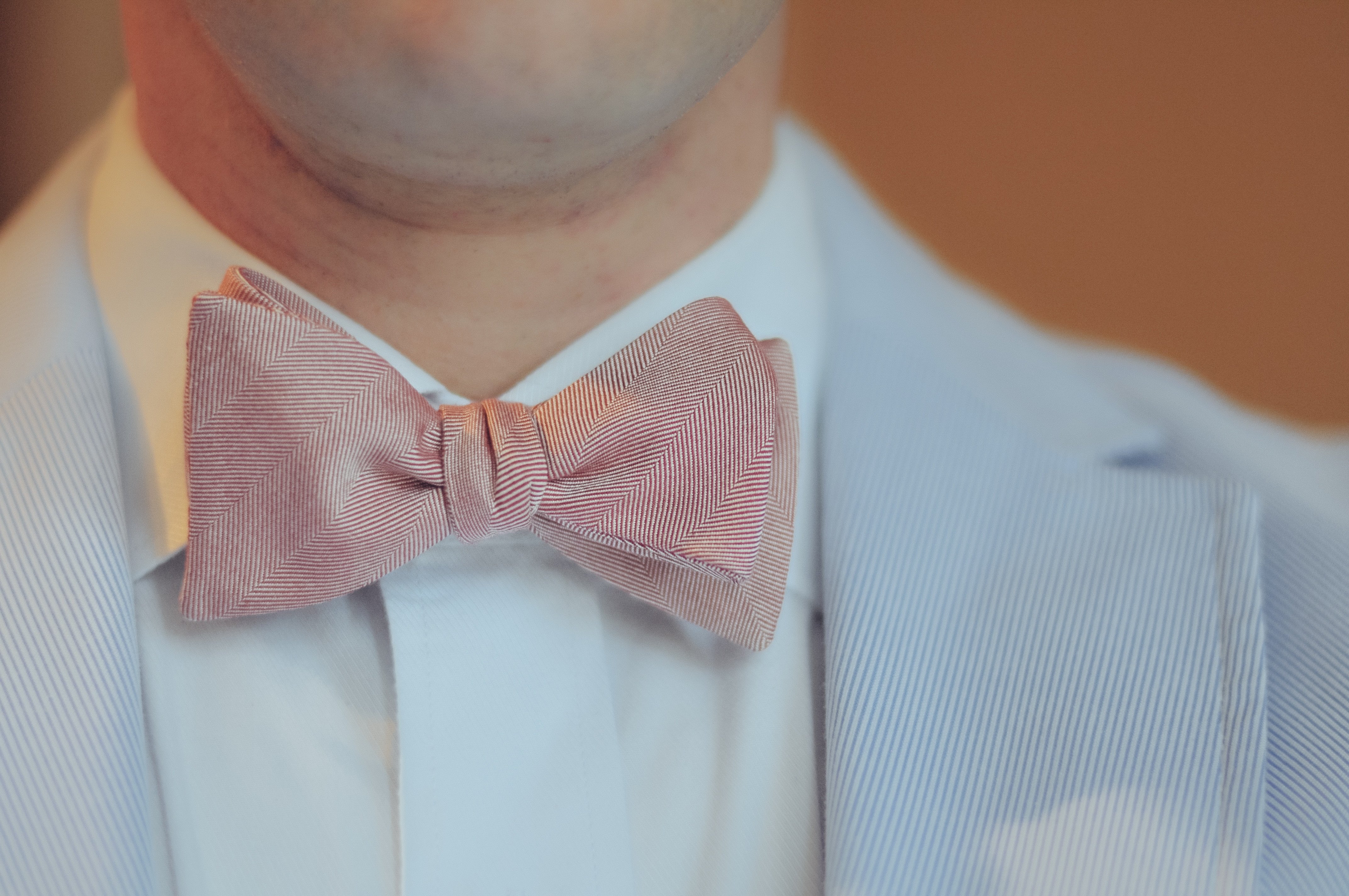Self Tied Pink Bowtie On Man With Blue Jacket