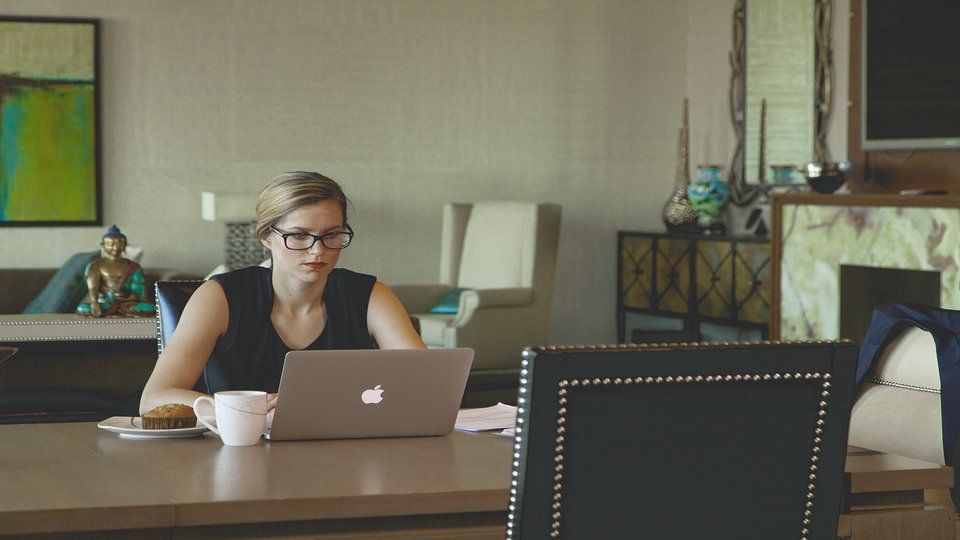 image of a girl working on a Macbook