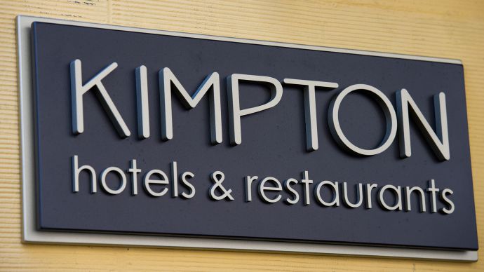 The Kimpton Hotel & Restaurants LLC sign is seen on the facade of the Hotel Monaco in San Francisco, California, U.S., on Tuesday, Aug. 9, 2011. Kimpton Hotel is a hospitality company that owns and manages hotels and restaurants operating in the U.S. and is based in San Francisco. Photographer: David Paul Morris/Bloomberg via Getty Images