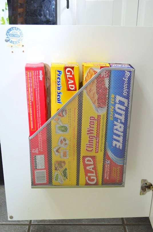 Attach a simple magazine rack to the back of your cupboard or pantry door to organize foils and clingwraps.