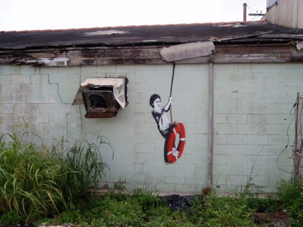 banksy-graffiti-street-art-boy-on-lifebuoy