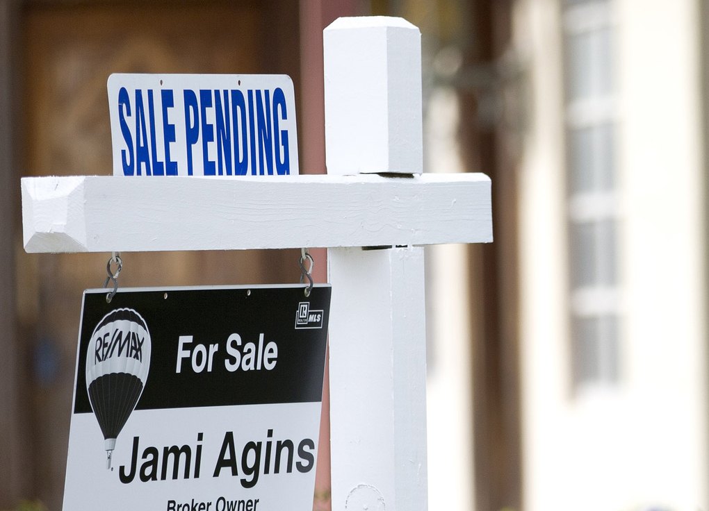FILE - In this Thursday, Jan. 8, 2015, file photo, a "sale pending" sits atop a realty sign outside a home for sale in Surfside, Fla. The National Association of Realtors releases its pending home sales index for June on Wednesday, July 29, 2015. (AP Photo/Wilfredo Lee, File)