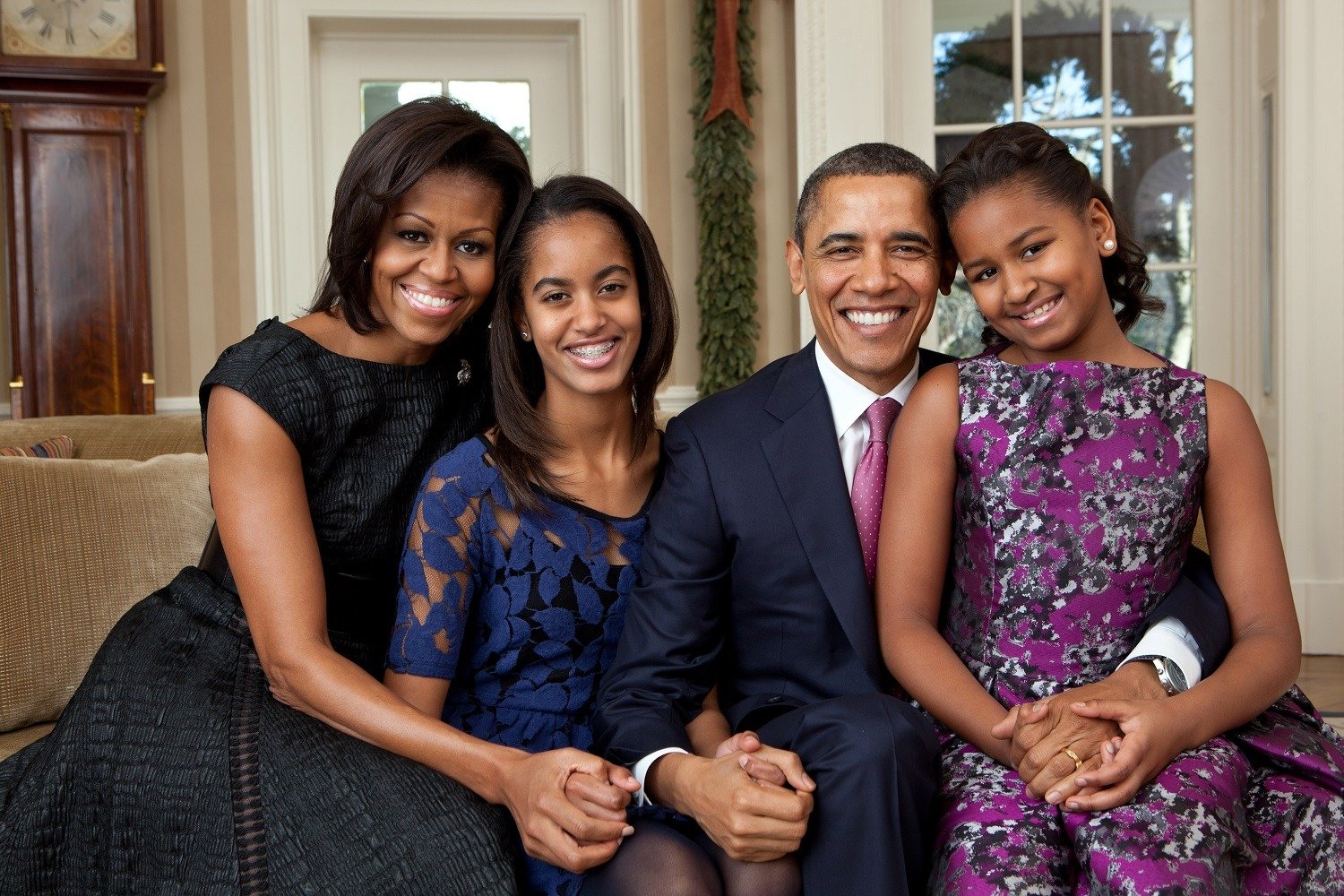 President Barack Obama, First Lady Michelle Obama, and their daughters, Sasha and Malia, sit for a family portrait in the Oval Office, Dec. 11, 2011. (Official White House Photo by Pete Souza) This official White House photograph is being made available only for publication by news organizations and/or for personal use printing by the subject(s) of the photograph. The photograph may not be manipulated in any way and may not be used in commercial or political materials, advertisements, emails, products, promotions that in any way suggests approval or endorsement of the President, the First Family, or the White House.ÃŠ