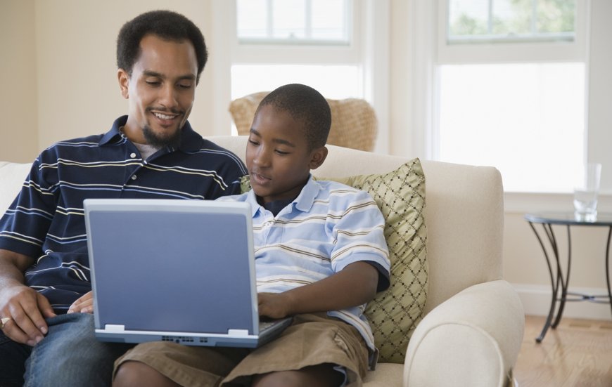 Young man and his son using a laptop