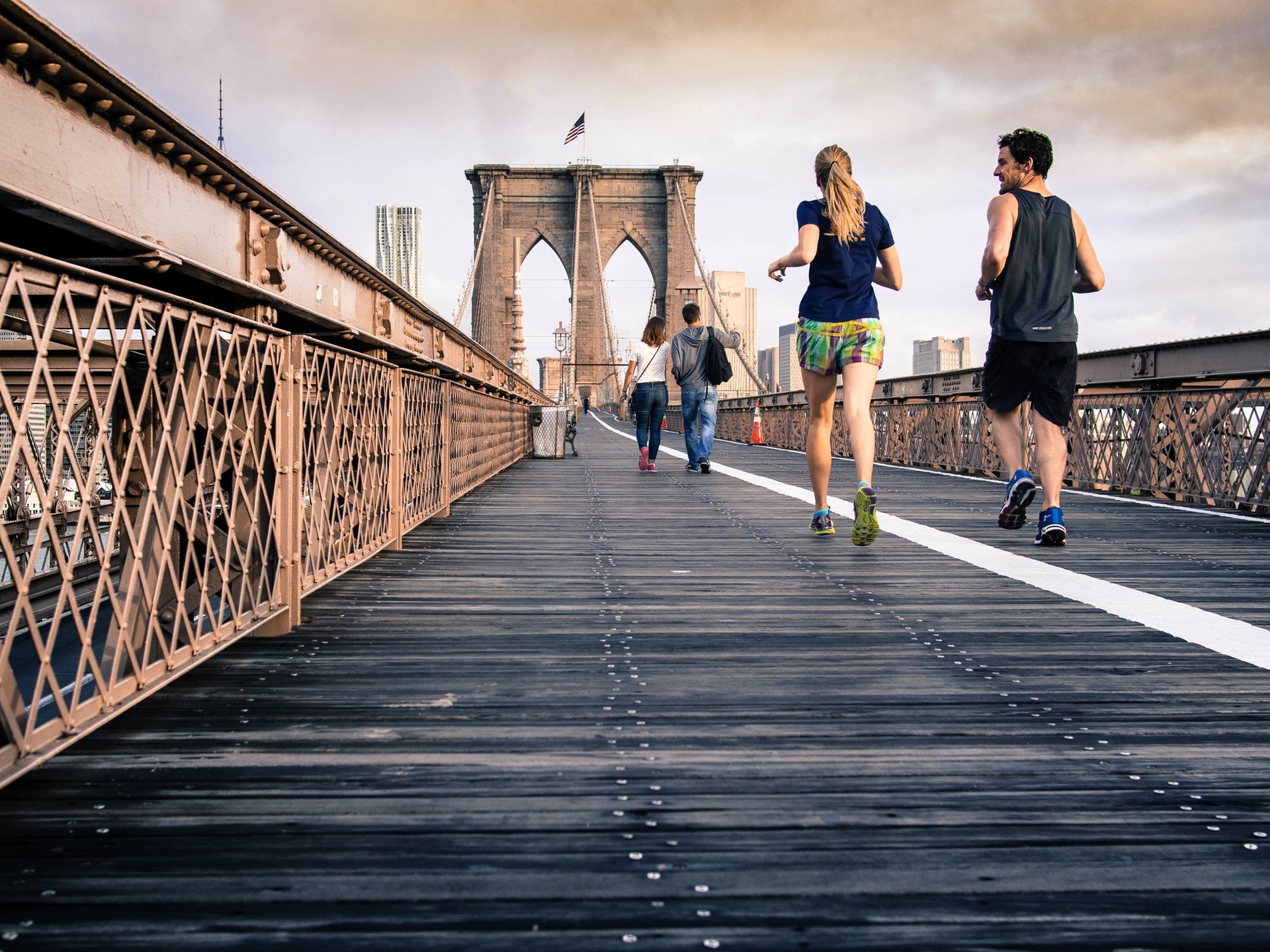 Two runners jog over Brooklyn bridge