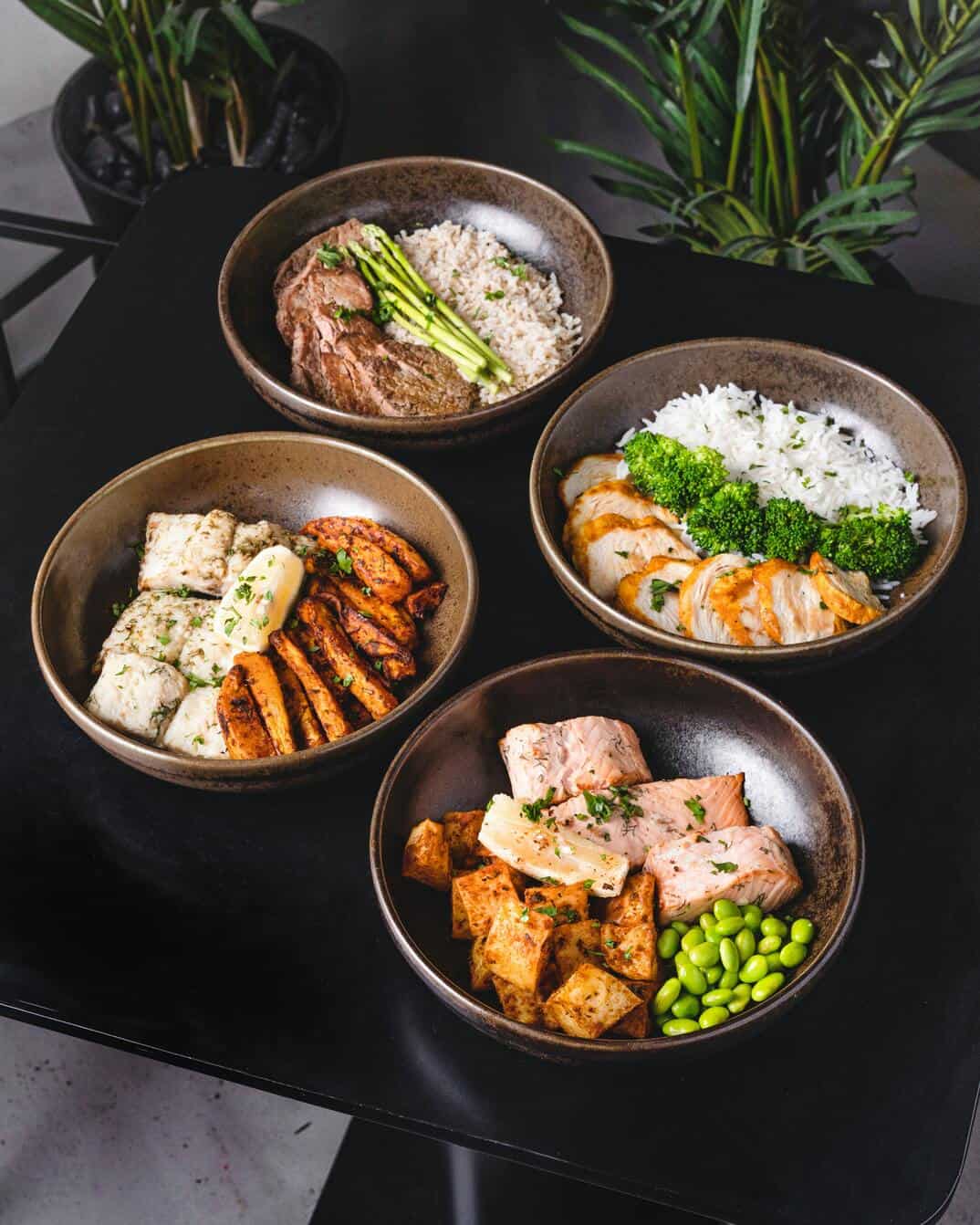 four different sets of cooked food on brown ceramic bowls