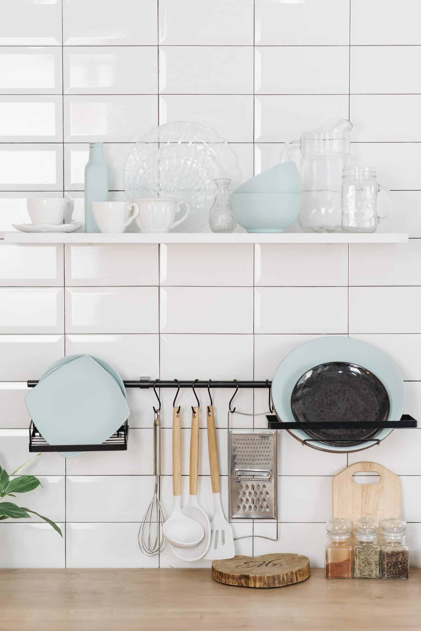 kitchenware on white wall and wooden table