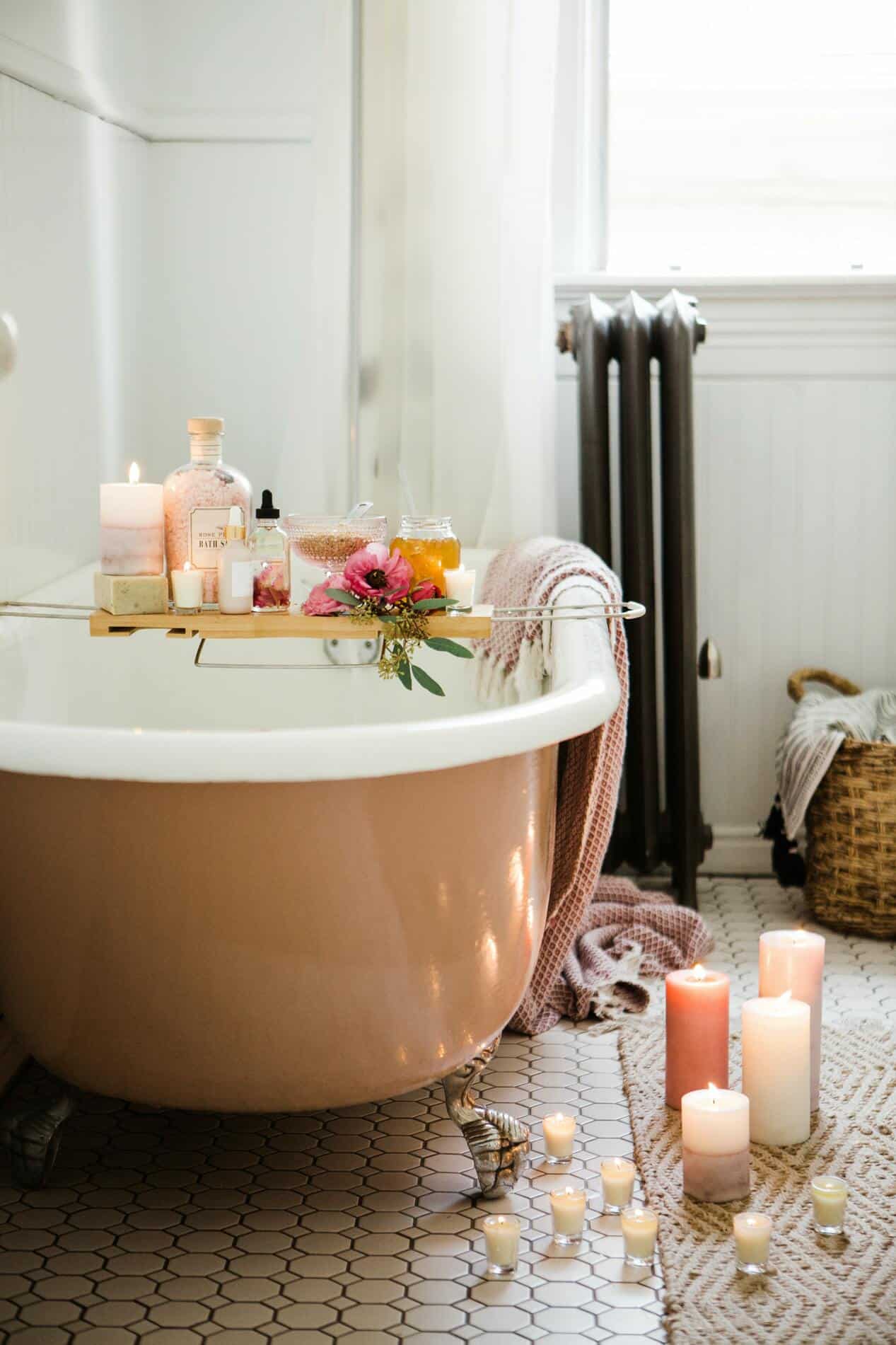relaxing bathtub with candles and essential oils