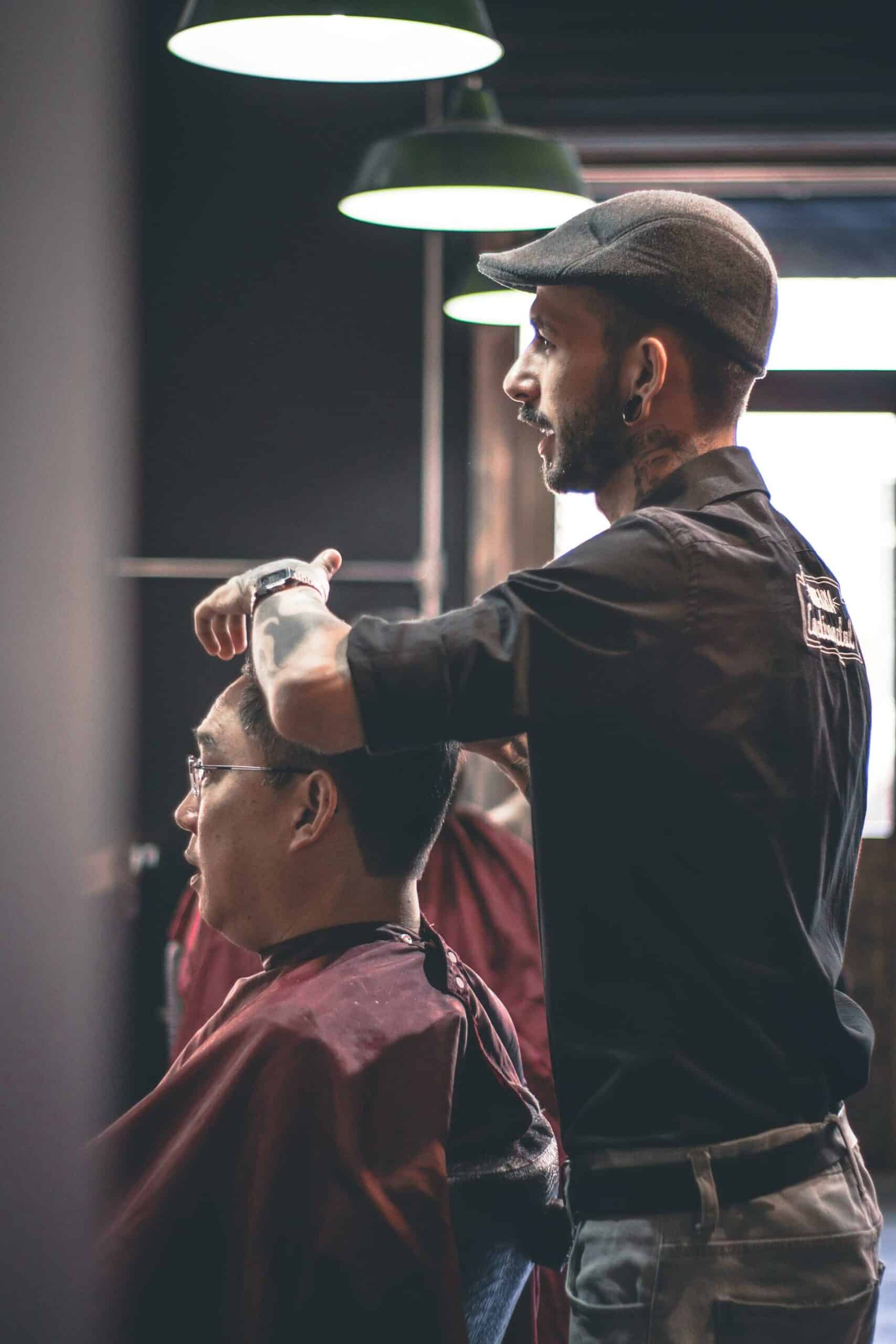 man getting a haircut at the barber shop